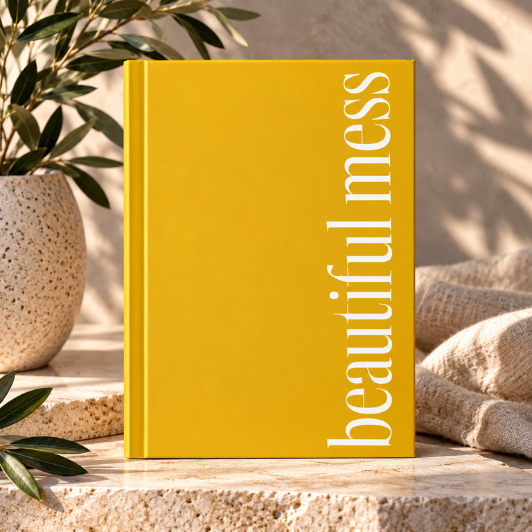 "Beautiful Mess" yellow hardcover journal by Unconditionally365 on a stone ledge with plant and textured cloth